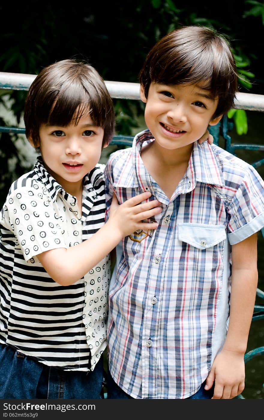 Little sibling boy smiling together outdoor