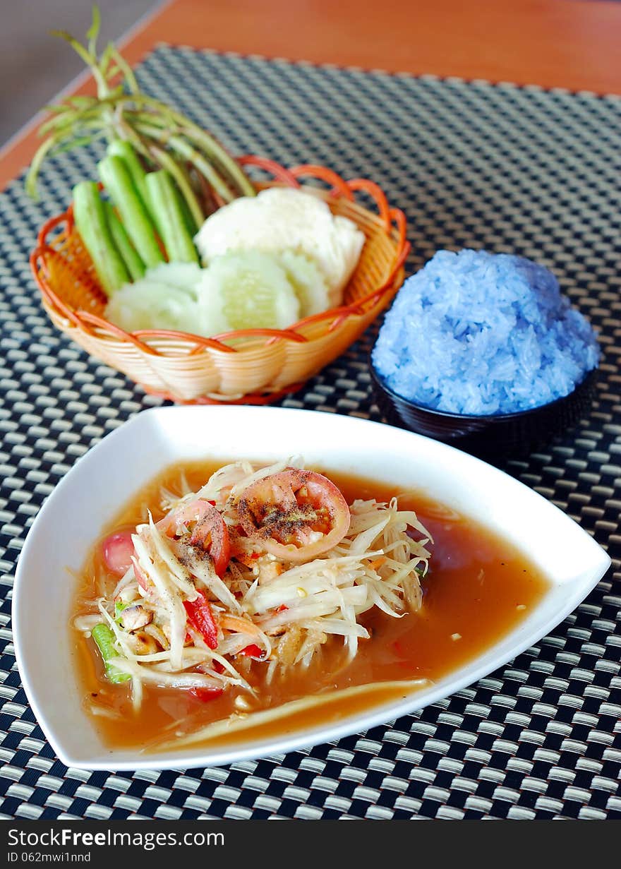 Papaya salad with violet sticky rice and fresh vegetable