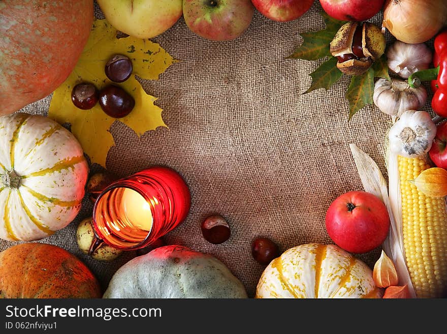 Thanksgiving vegetables, fruits border. Pumpkins, corn, apple on a natural background frame. Thanksgiving vegetables, fruits border. Pumpkins, corn, apple on a natural background frame