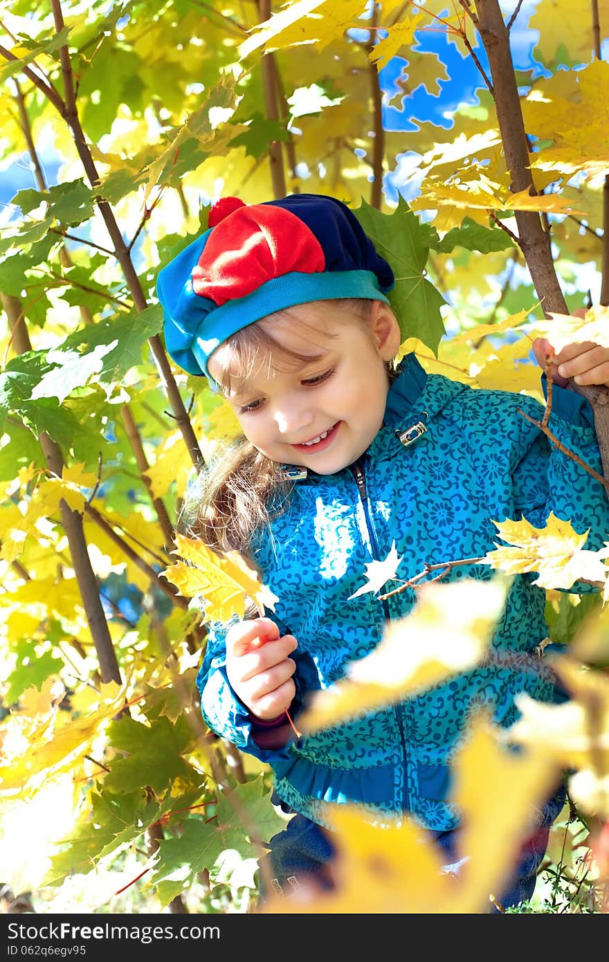 Portrait of a little girl holding a bunch of leaves