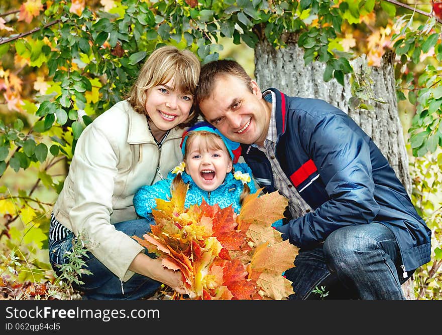 Portrait Of Family Relaxing In The Park