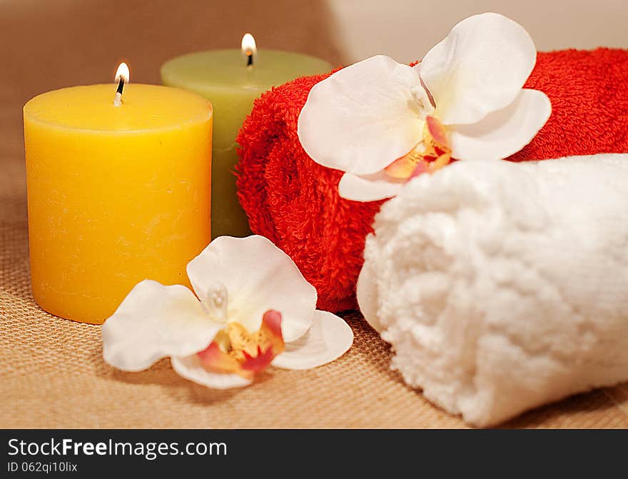 Two towels with orchid and candles