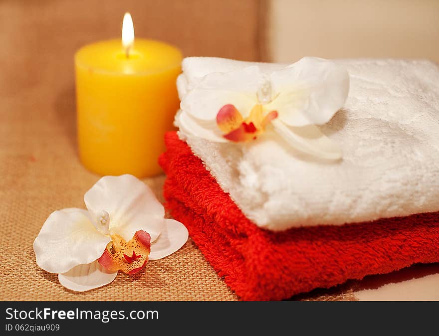 Two towels for spa with sea shell, orchid and candles. Two towels for spa with sea shell, orchid and candles