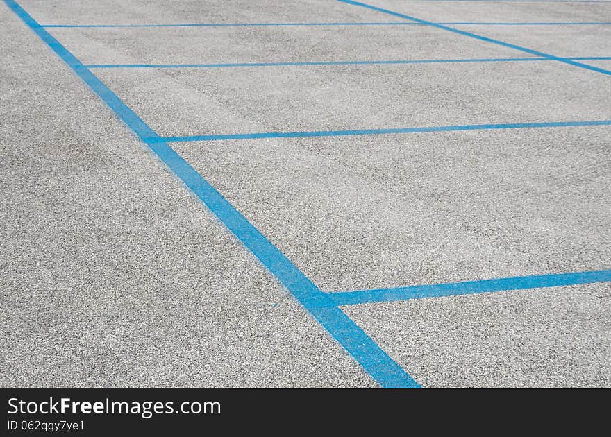 Detail of empty parking spaces with blue stripes.