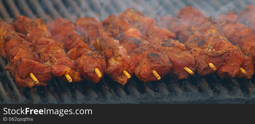 Meat skewers grilling on a charcoal grill. Meat skewers grilling on a charcoal grill