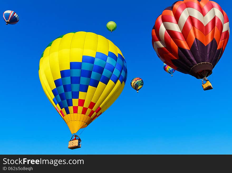 Colorful hot air balloons against blue sky