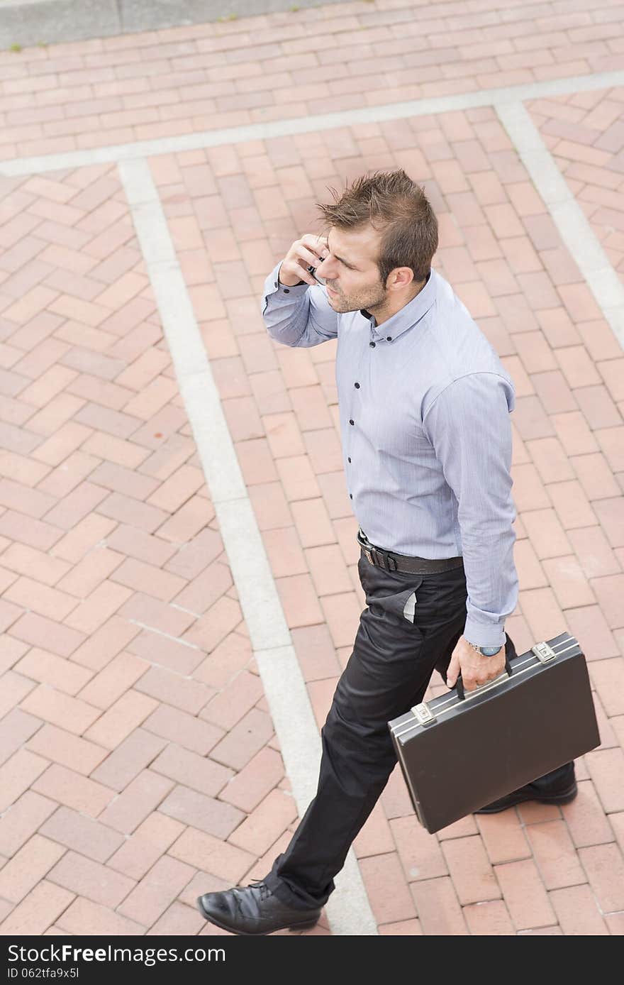 Businessman with briefcase walking in the street.