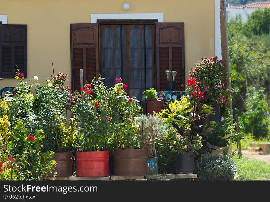 Small, beautiful house with flowers in front of the Windows