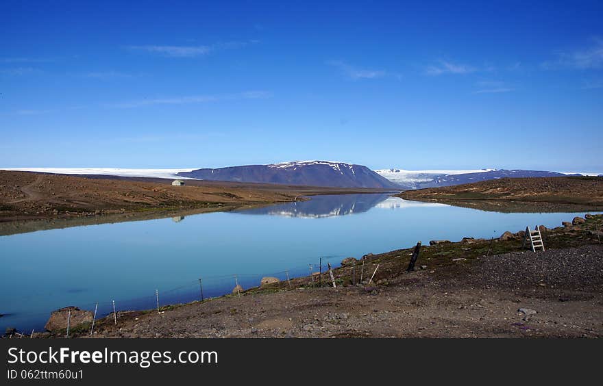 Glacier lake Hvitarvatn with in reflection the Langjökull glacier on a great summer day in Iceland. Glacier lake Hvitarvatn with in reflection the Langjökull glacier on a great summer day in Iceland.