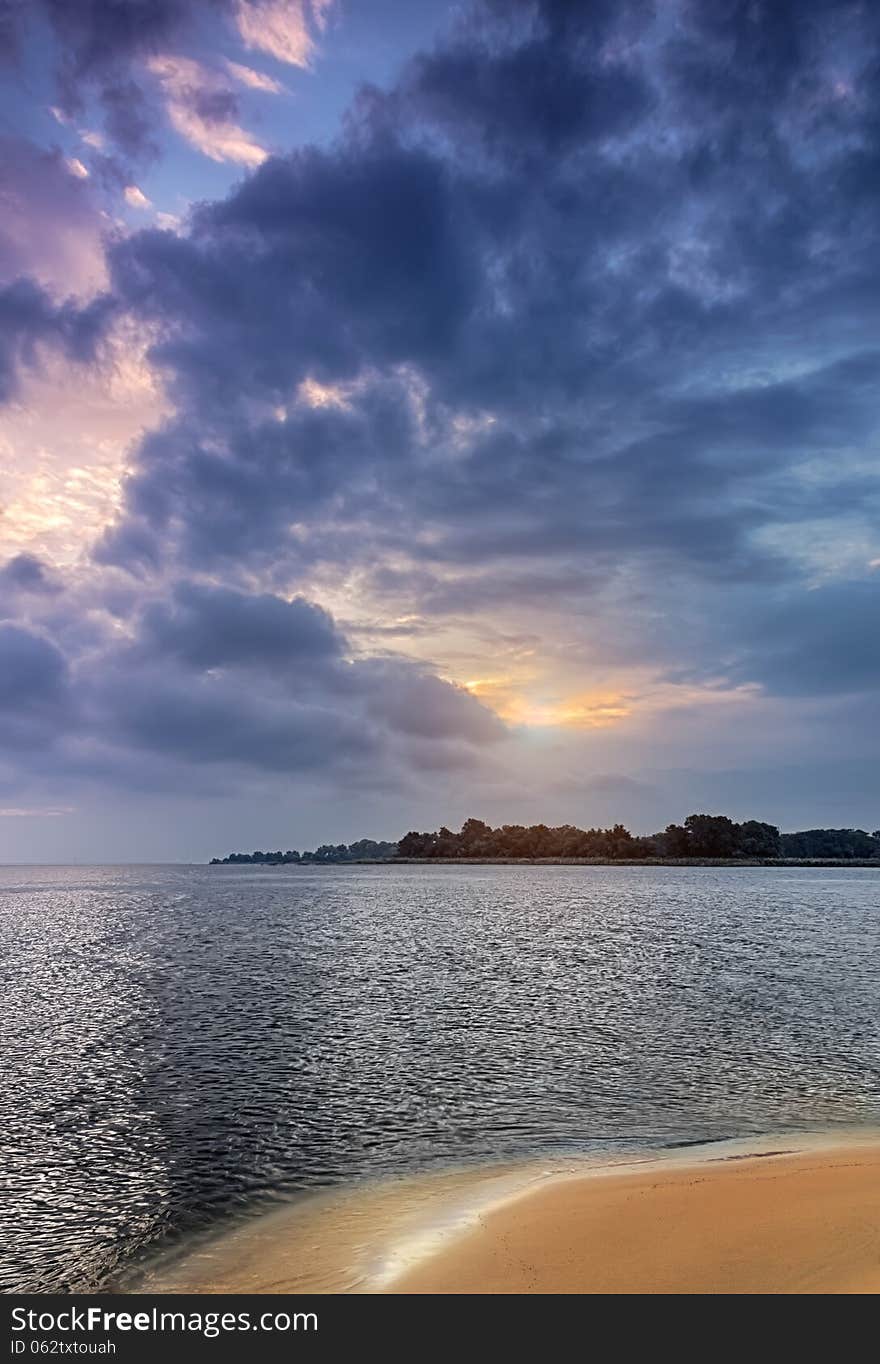 Photo of sunrise on the shore of a small lake