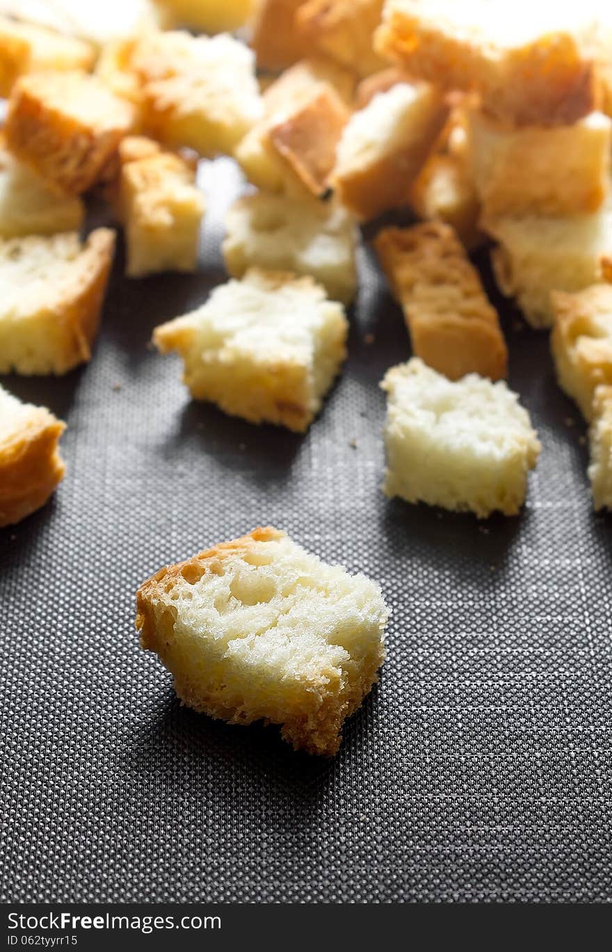 Macro photo on a black background with white bread crumbs. Macro photo on a black background with white bread crumbs