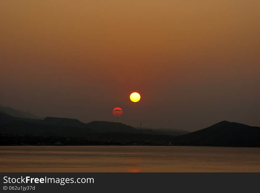 Double sunrise at seaside