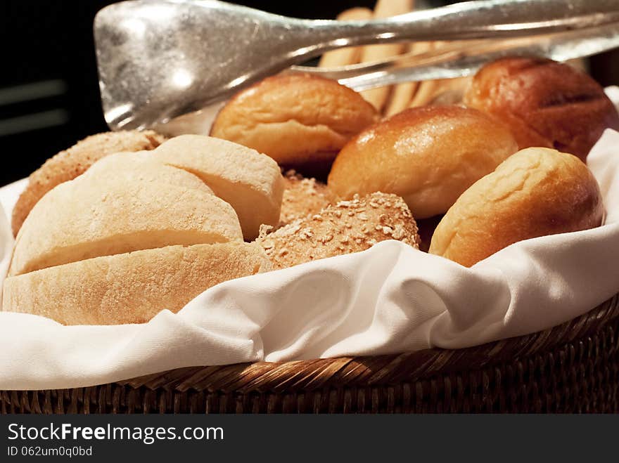 A basket containing assorted breads. A basket containing assorted breads