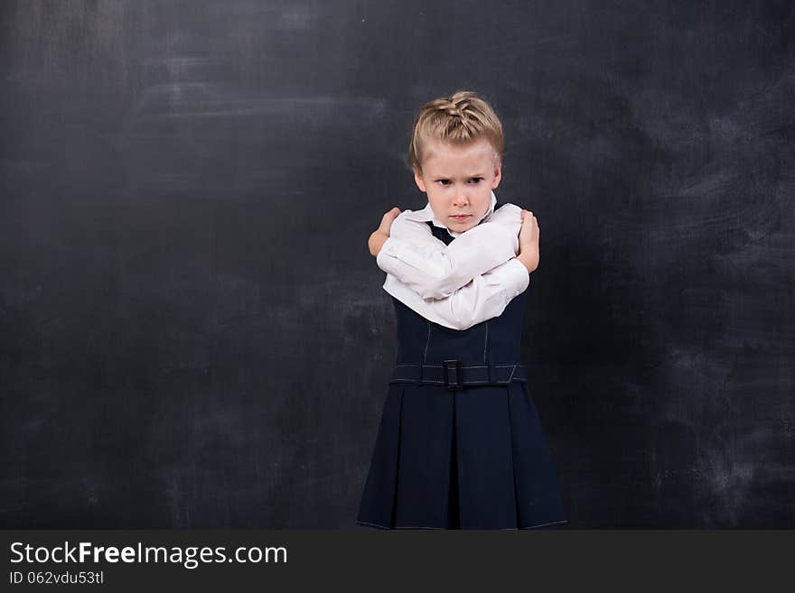 Schoolgirl Leaning Her Forehead Against Blackboard