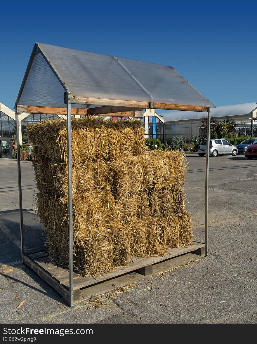 Covered Haystack in a parking lot with a nice blue sky.