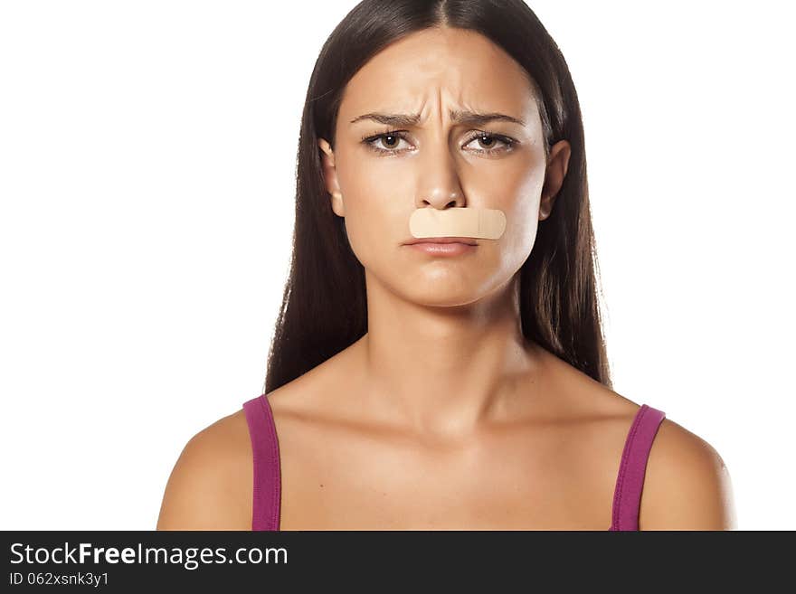 Young brunette put the patch under her nose because of bad waxing her mustache. Young brunette put the patch under her nose because of bad waxing her mustache