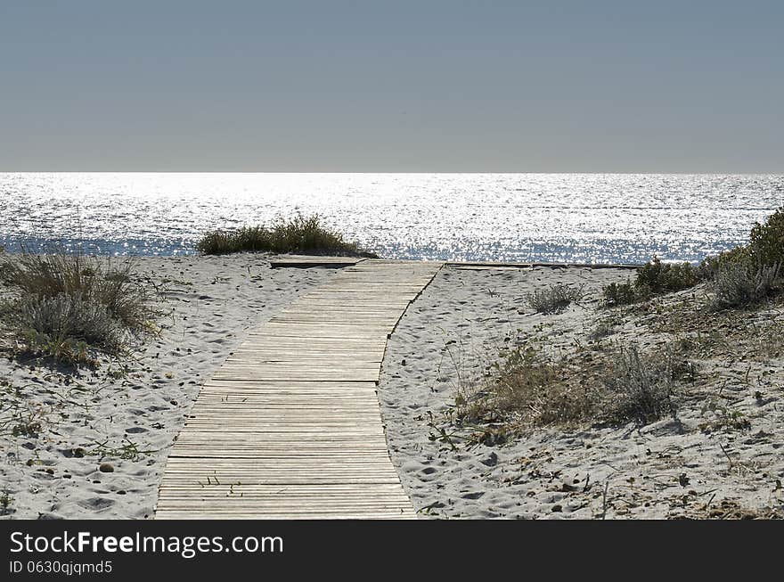 Sunrise on the sea and walkway over the sand dunes to reach the sea. Sunrise on the sea and walkway over the sand dunes to reach the sea.