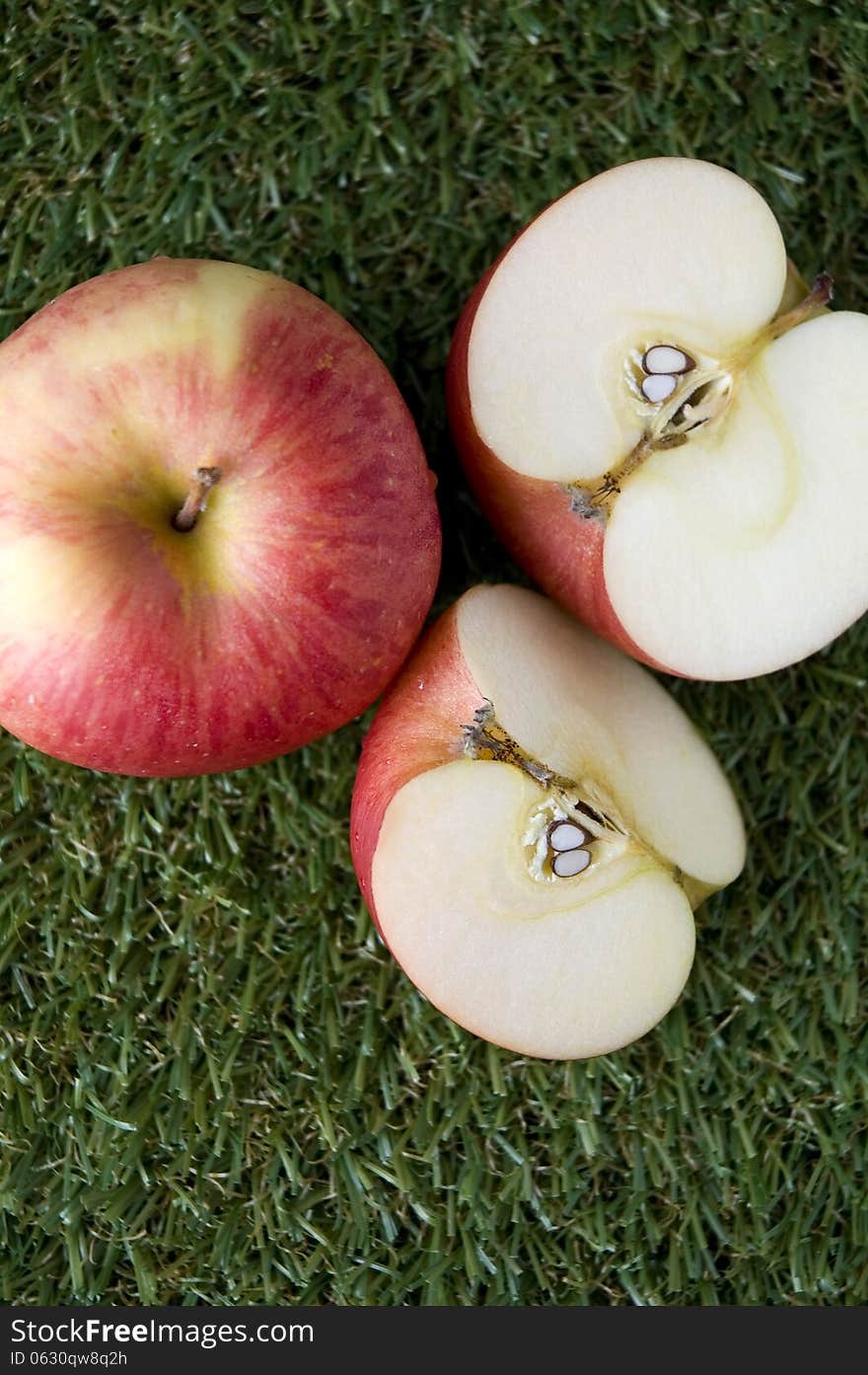 Red apple on green grass