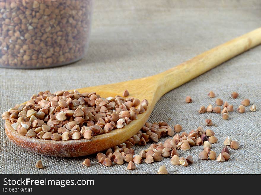 Buckwheat groats in a wooden spoon