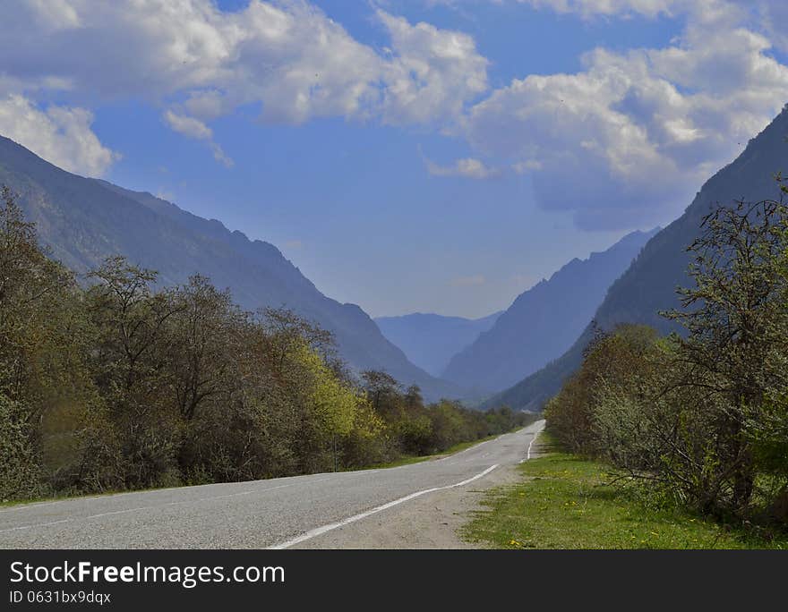 Road stretches into the distance among the mountains. Road stretches into the distance among the mountains