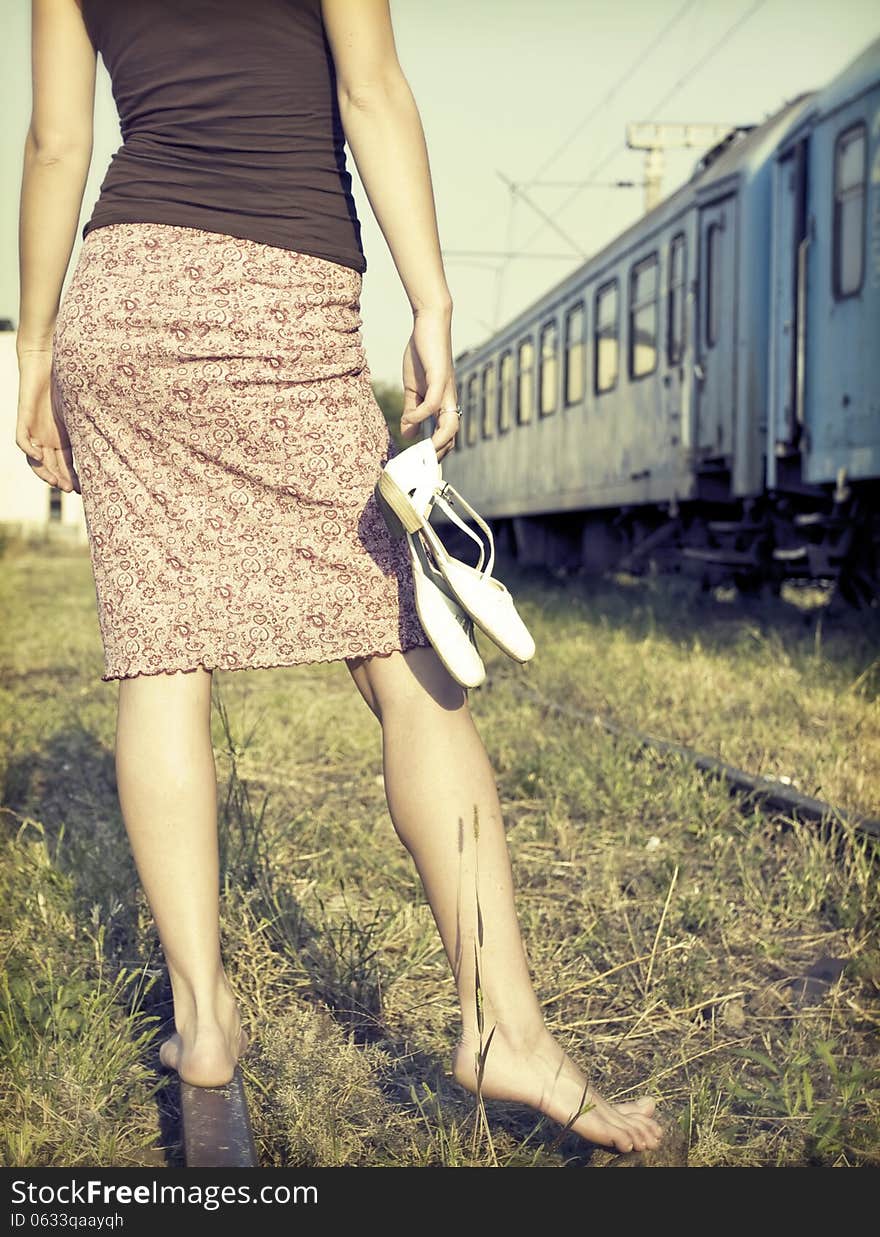 Barefoot girl at the railways