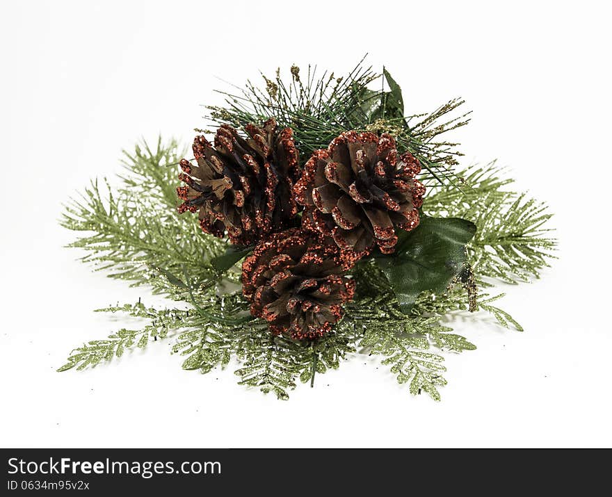 Christmas ornamental glittery red pine cones with spruce branches against a white background. Christmas ornamental glittery red pine cones with spruce branches against a white background