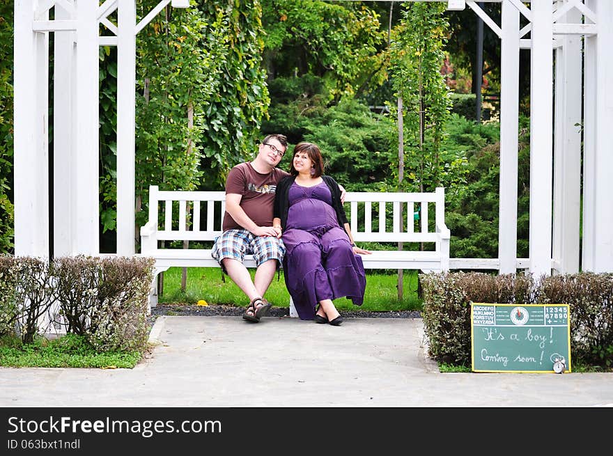 Happy pregnant women with her husband in the park. Happy pregnant women with her husband in the park.