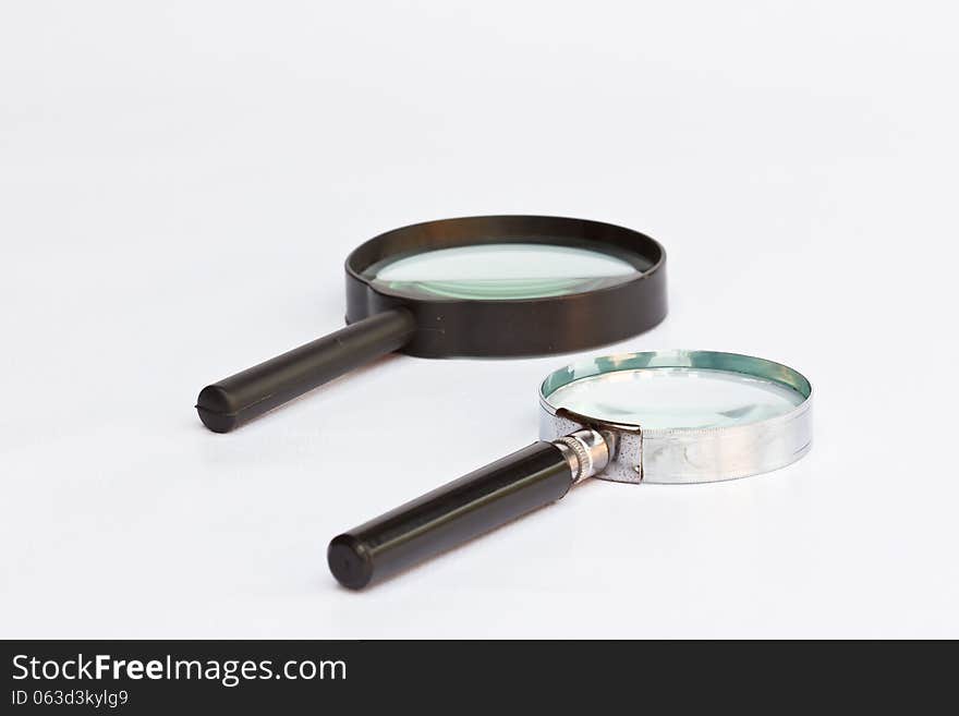 The old two magnifying glass on white background. The old two magnifying glass on white background.