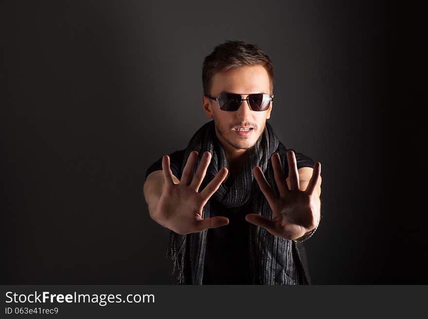 Portrait of a handsome guy, wearing sunglasses, Low-key image