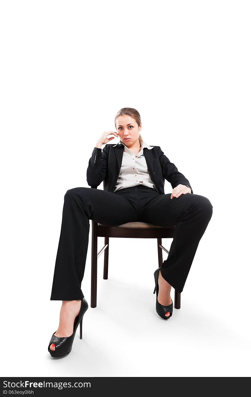 Attractive businesswoman sitting on a chair isolated on white