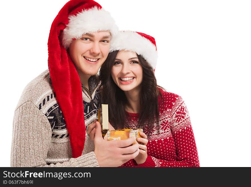 Young happy couple near a Christmas tree. Over white background