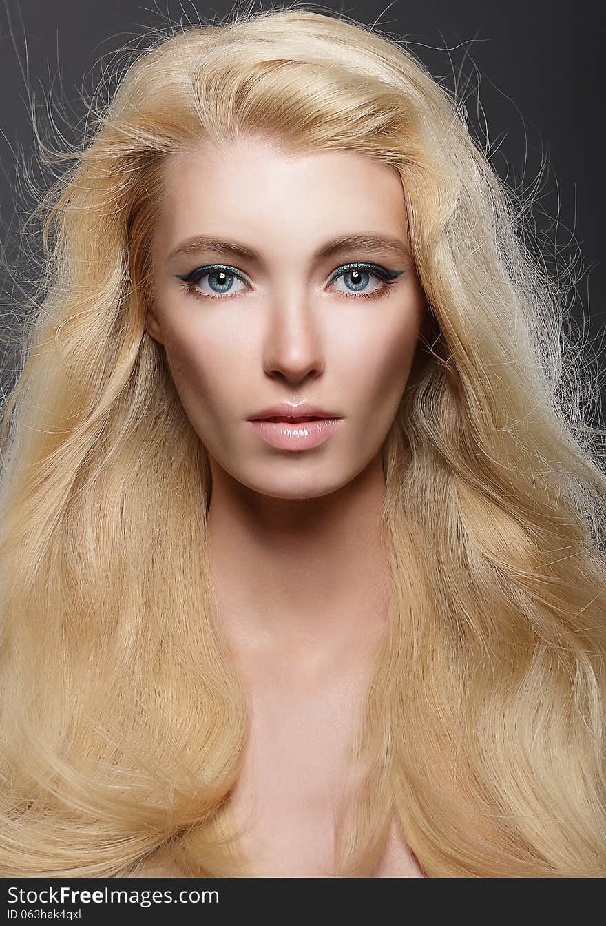 Pure Beauty. Portrait of Young Blonde with Healthy Flowing Hair