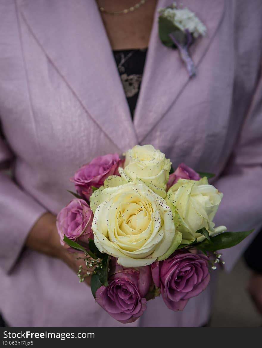 Wedding bouquet of roses in hands. Wedding bouquet of roses in hands