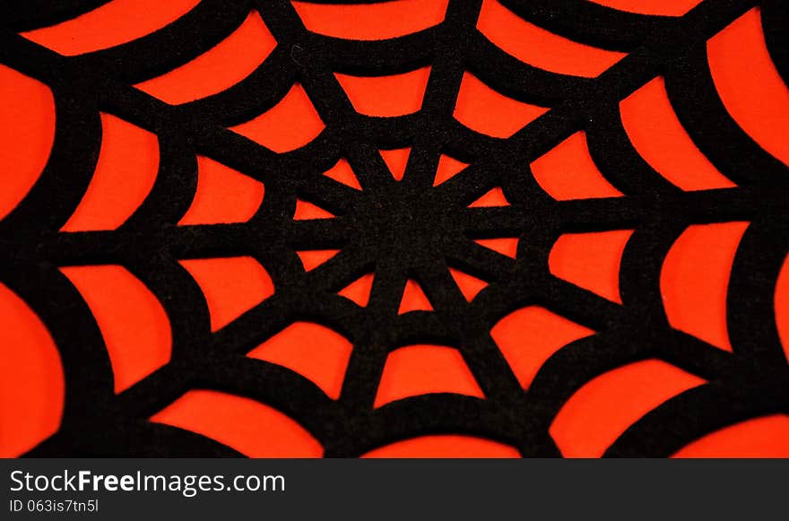 Black spider web on an orange background