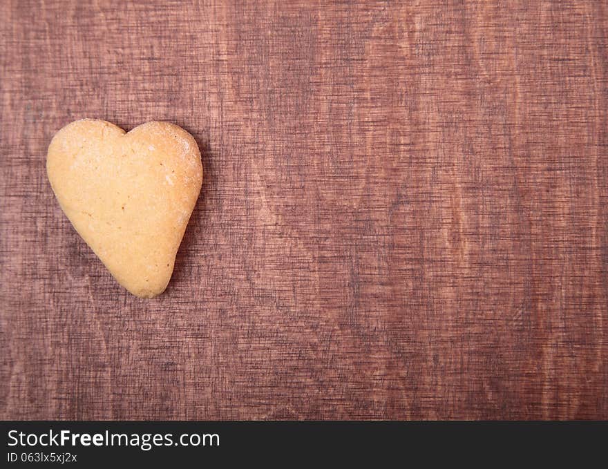 Valentine background.Cookies in the form of heart on a wooden background