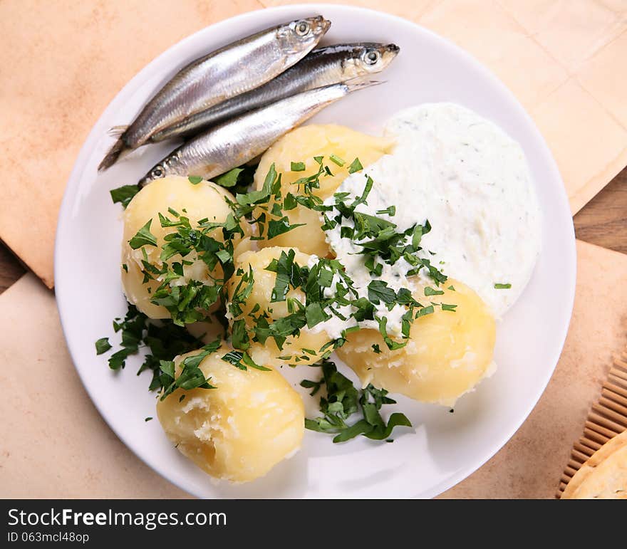 Potato and small fish with sauce