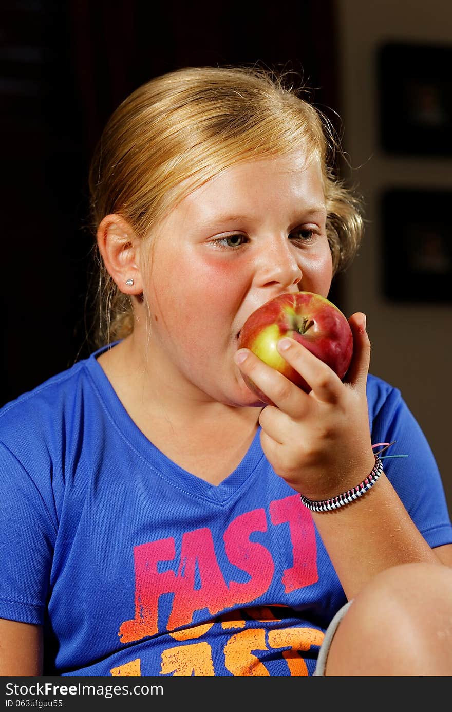 Portrait of young girl eating apple