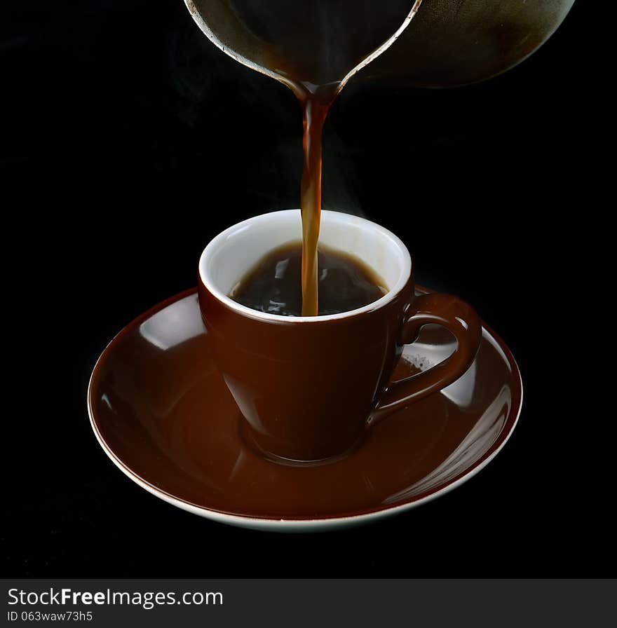 Pouring coffee in a cup