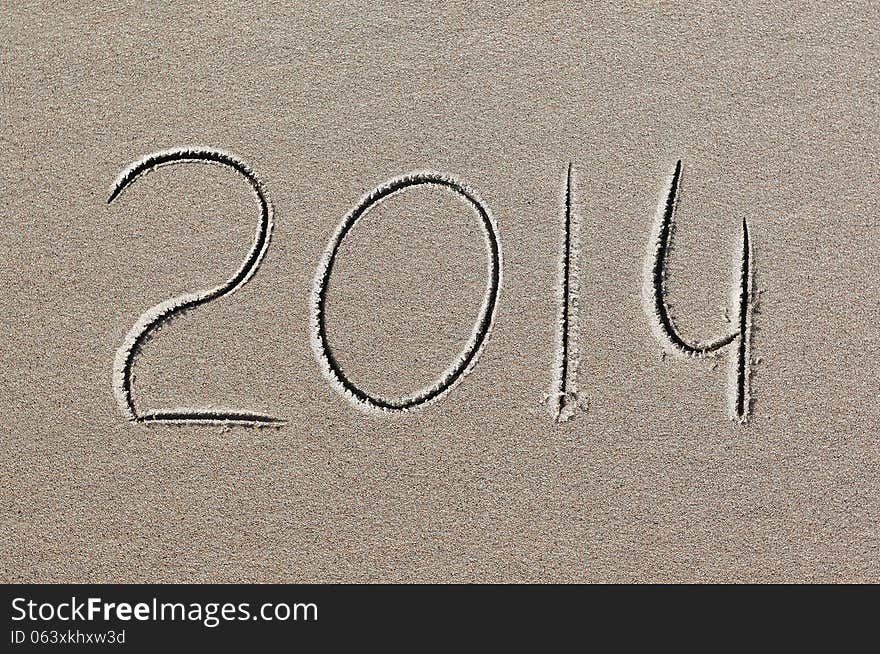 New year 2014 written in sand