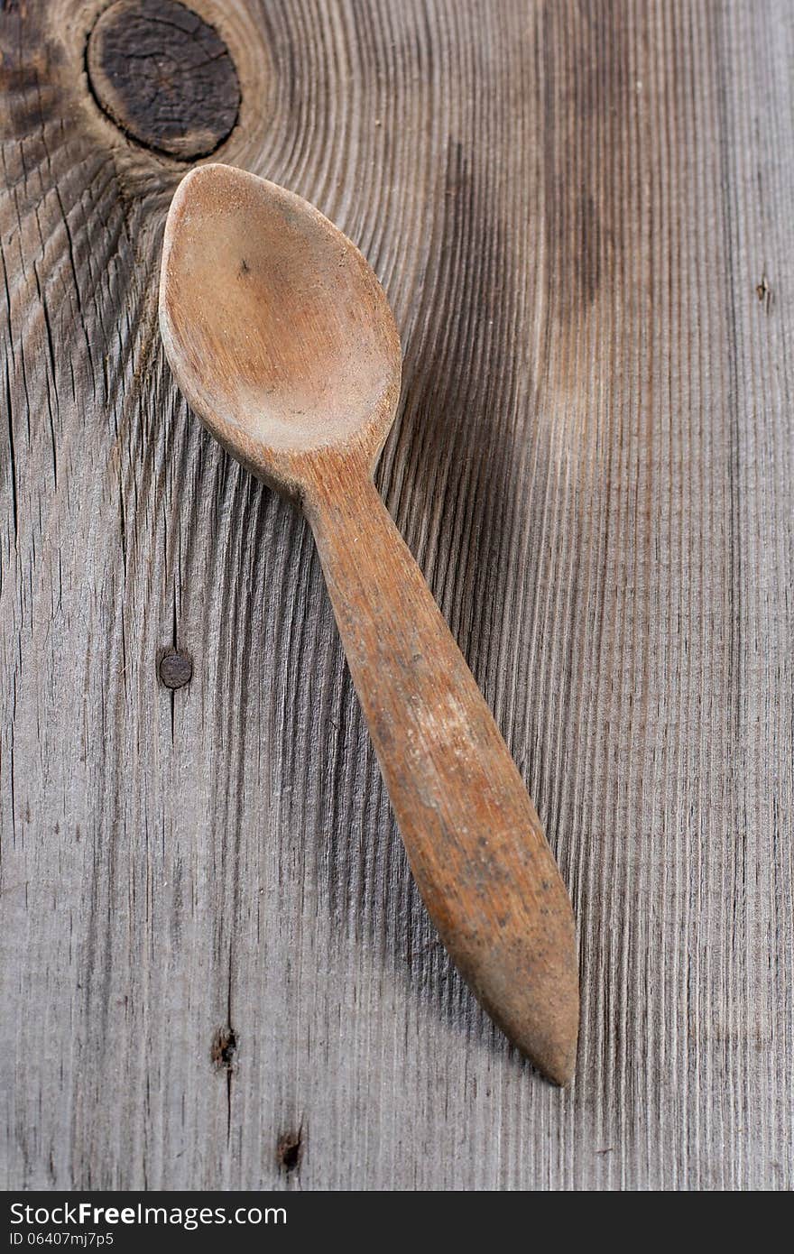 Old wooden spoon on wooden background. Old wooden spoon on wooden background