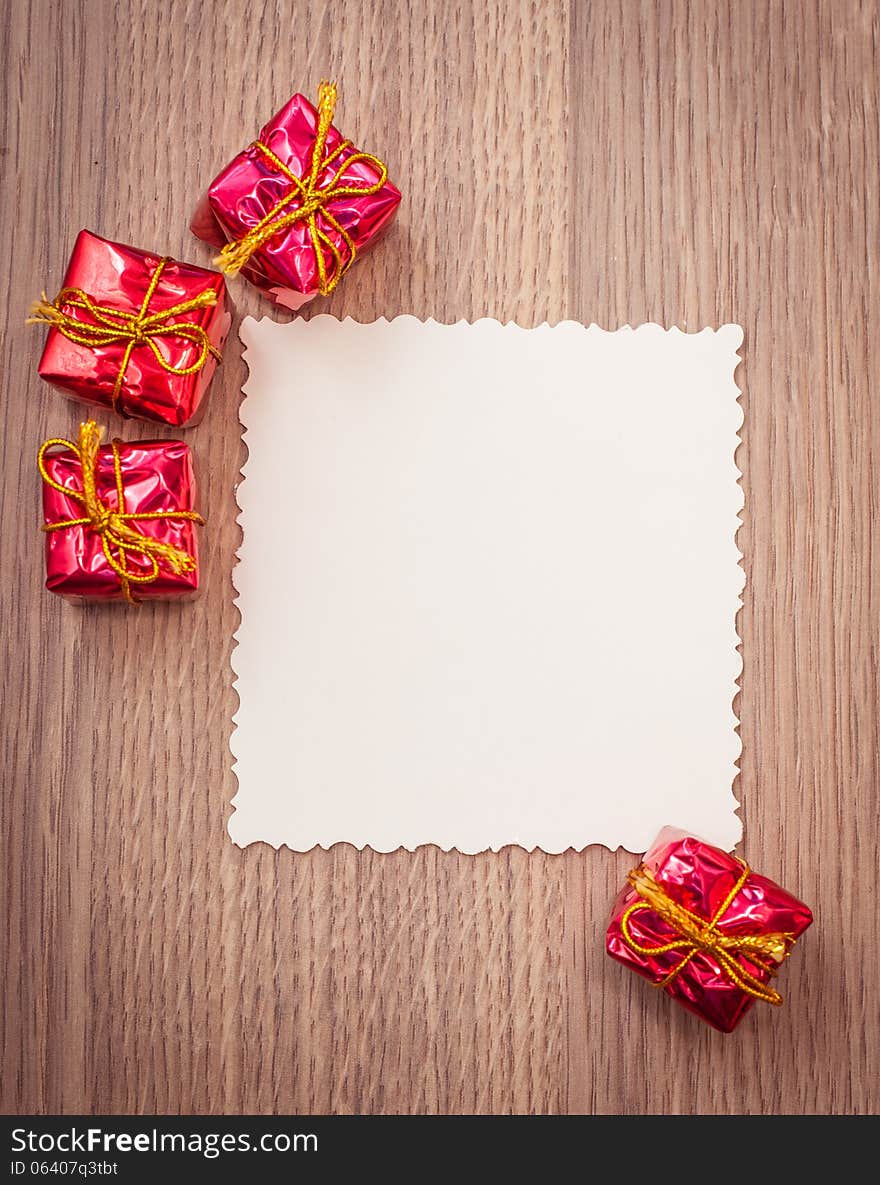 Red decorative gifts on wooden background