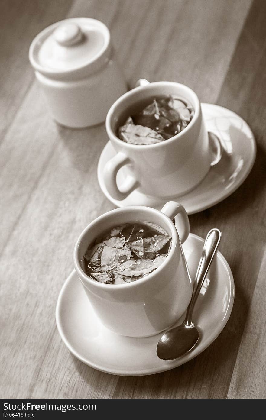 Cups of Coca Tea on Wooden Table