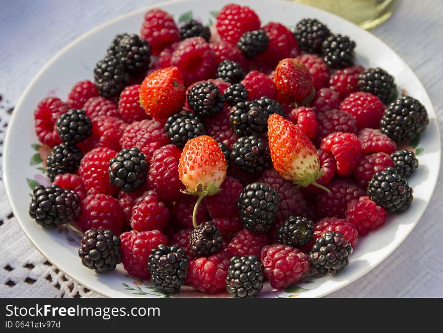 Wildberries, strawberries and raspberries in a bowl. Wildberries, strawberries and raspberries in a bowl