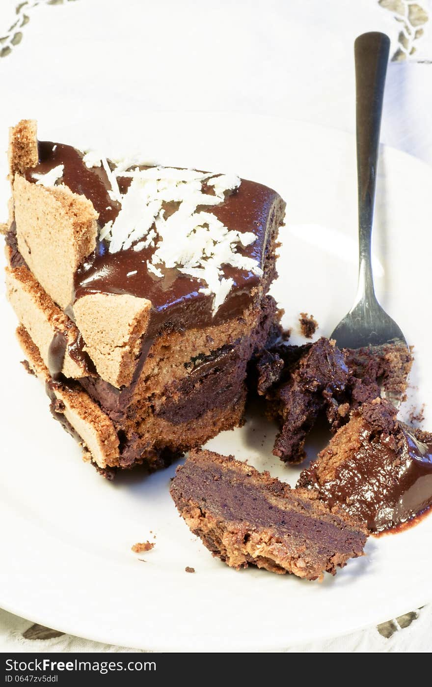 Slice of chocolate cake decorated with white chocolate flakes. From the series French Desserts