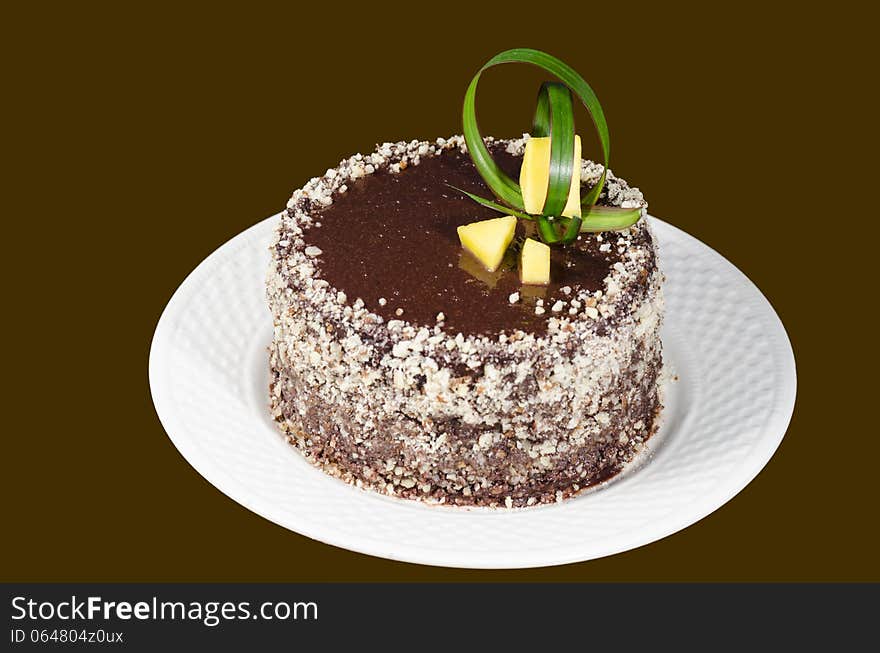 French chocolate cake covered with mirror chocolate icing on brown background. From the series French Desserts