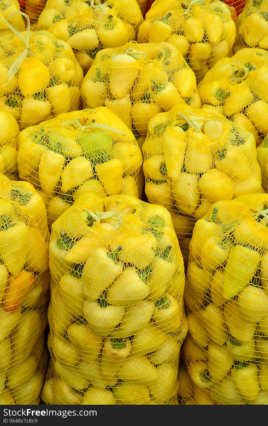 Yellow, hot bell peppers in plastic sacks. Yellow, hot bell peppers in plastic sacks