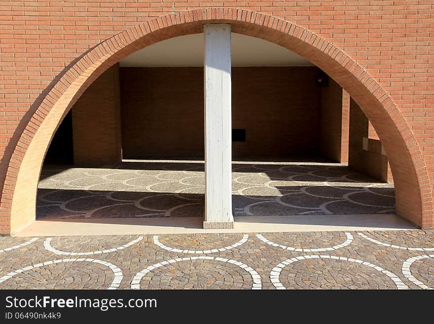 View of architectural detail of a wall of modern construction. In the picture you can see the red bricks used in some modern building in Italy