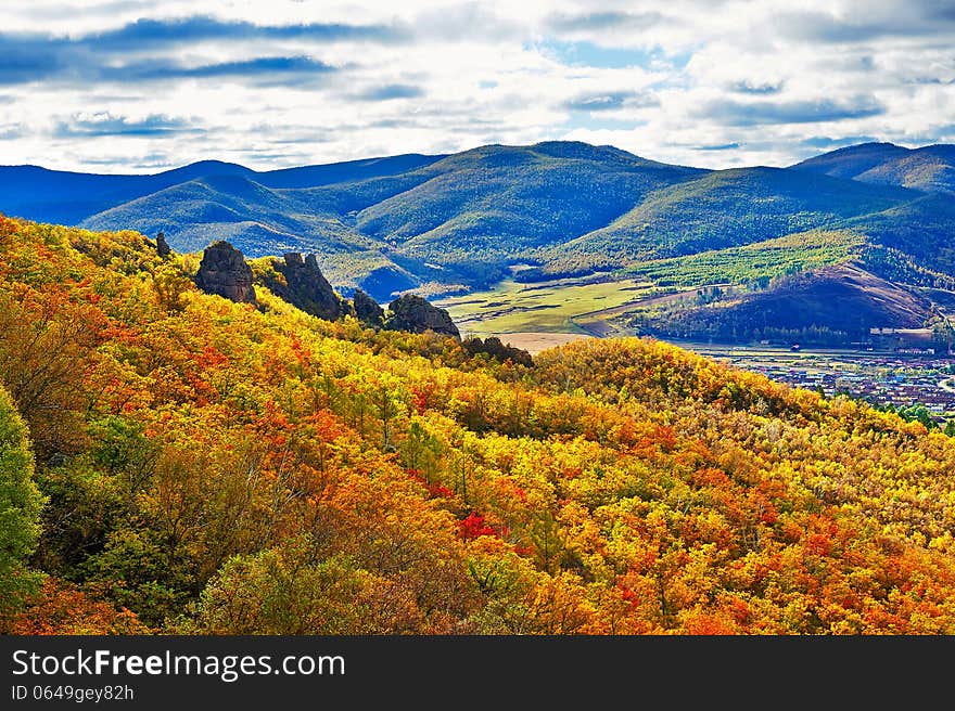 The autumn forest and mountains