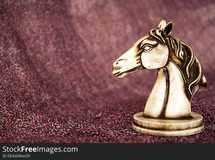 Statuette of horse on the purple background