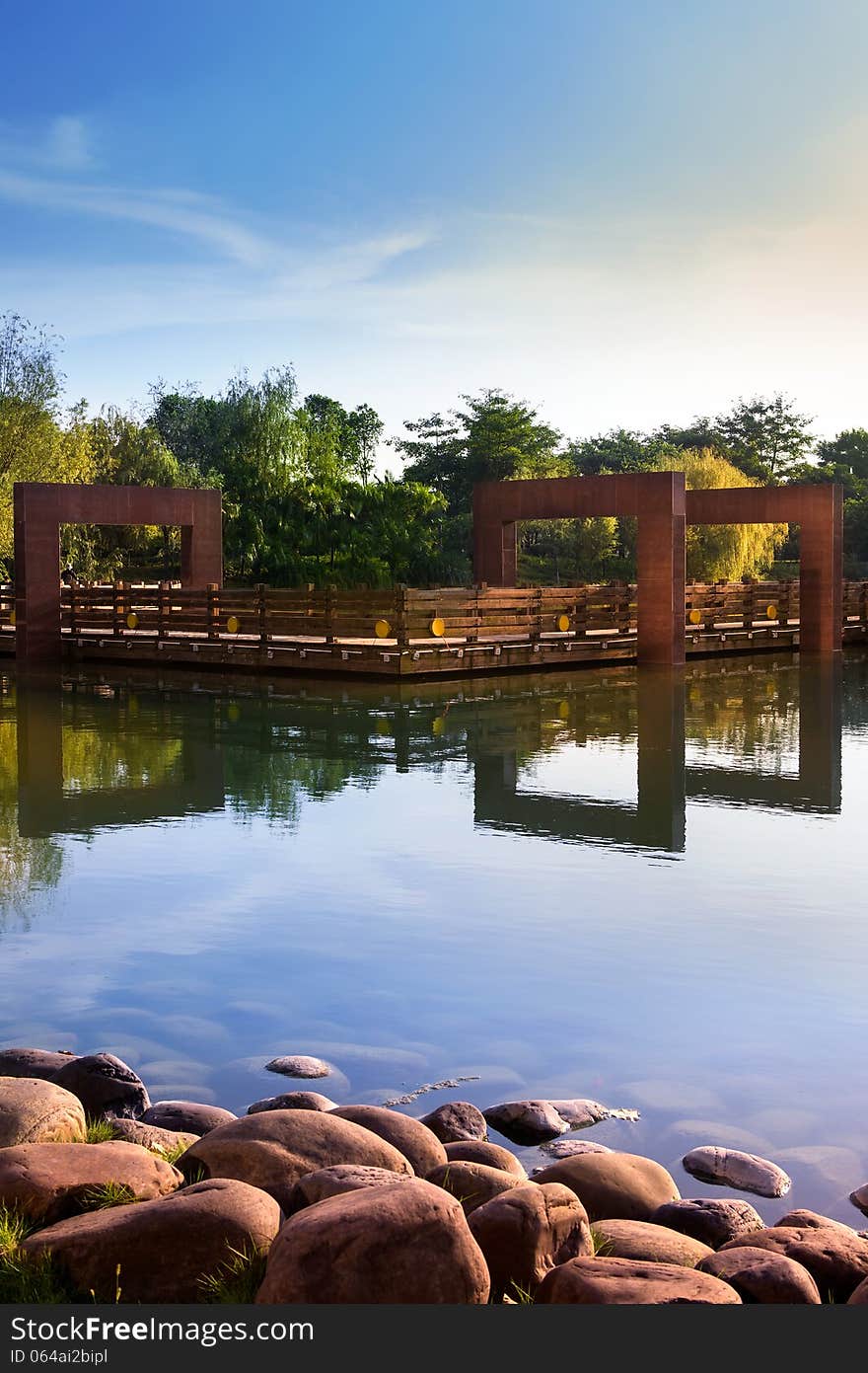 Modern garden with a calm pool and a wooden terrace in Liuzhou City Park,China. Modern garden with a calm pool and a wooden terrace in Liuzhou City Park,China